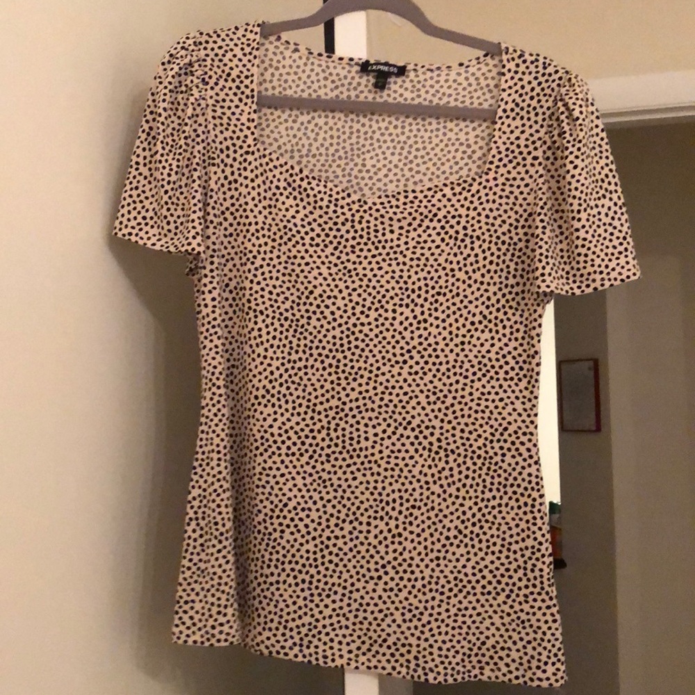 Express top with cream base and black dots
